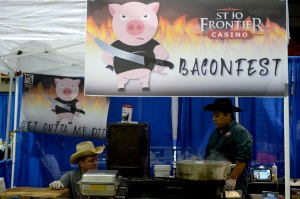 Brice Dewsbury, 28, and Jose Reys, 41, from the Frontier Casino prepare their bacon chicken fajitas for the recipe contest in the 1st Annual BaconFest in St. Joseph, Mo., on Sept. 27, 2014. “We were just sitting around drinking beer when I thought, ‘Why not make bacon fajitas?’” Dewsbury said. 